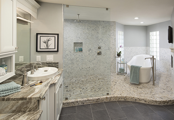 Remodeled master bathroom with rain showerhead and standalone tub